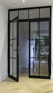 Crittall style steel double door with a toplight