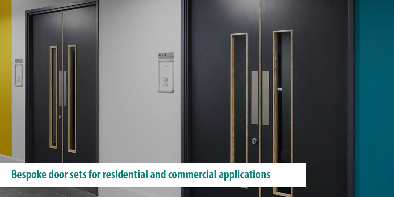 Dark double door sets with vision panels in commercial development